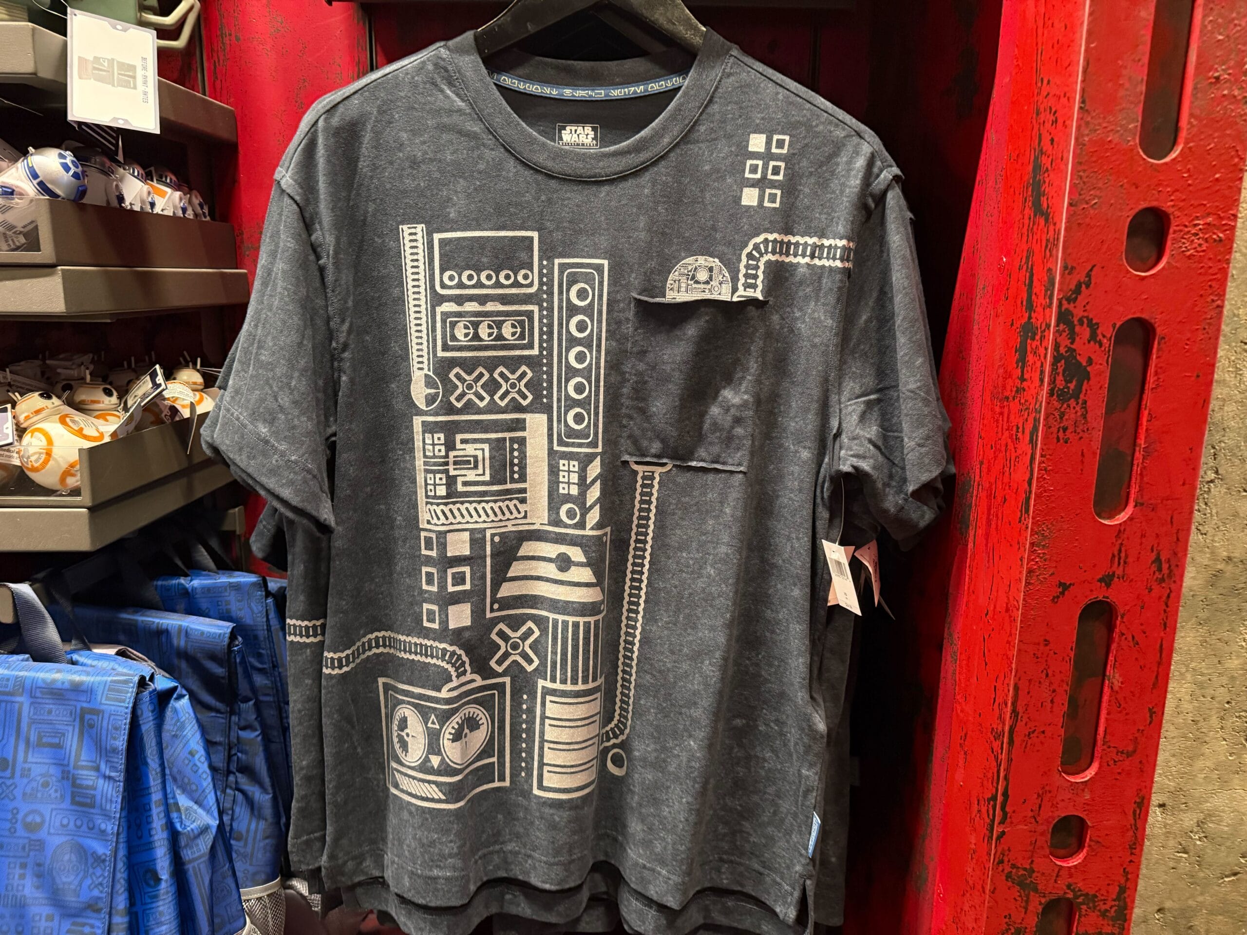 Black t-shirt with white, geometric Star Wars droid designs, ideal for Disneyland Droid Depot fans—no castle pictured to compare.