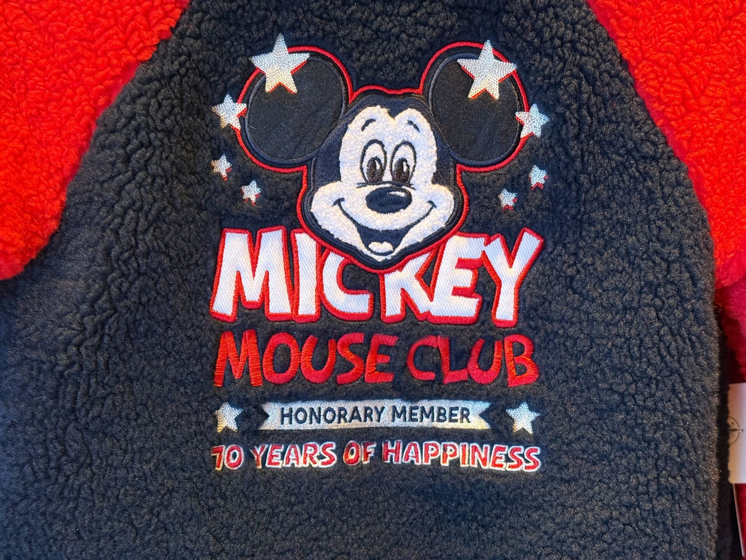 Close-up of Mickey Mouse Club patch, honoring 70th anniversary with Mickey’s face, stars, and honorary membership text.