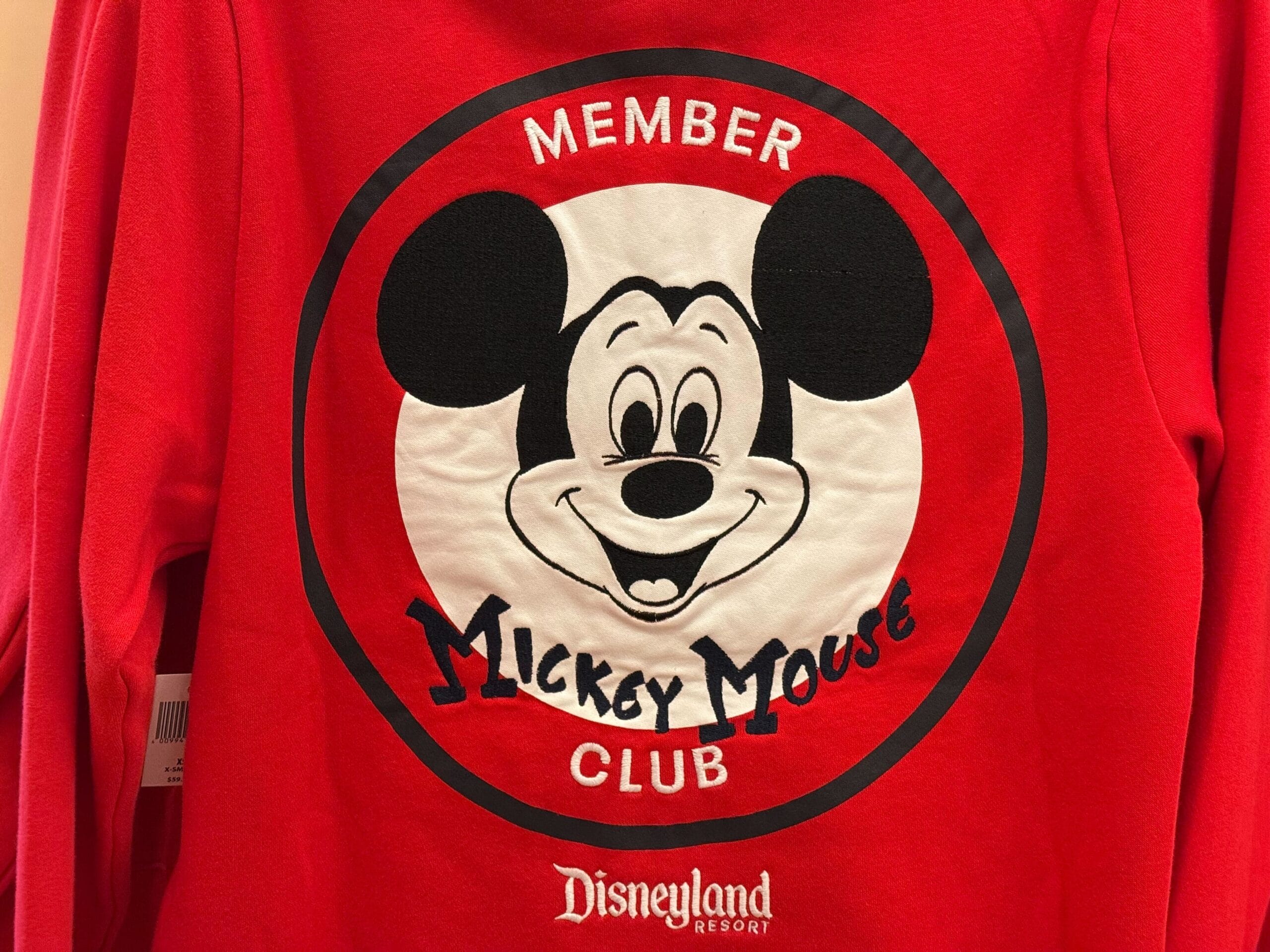 Red sweatshirt featuring a Mickey Mouse face and "Member Mickey Mouse Club"—official Disneyland 70th anniversary merchandise.