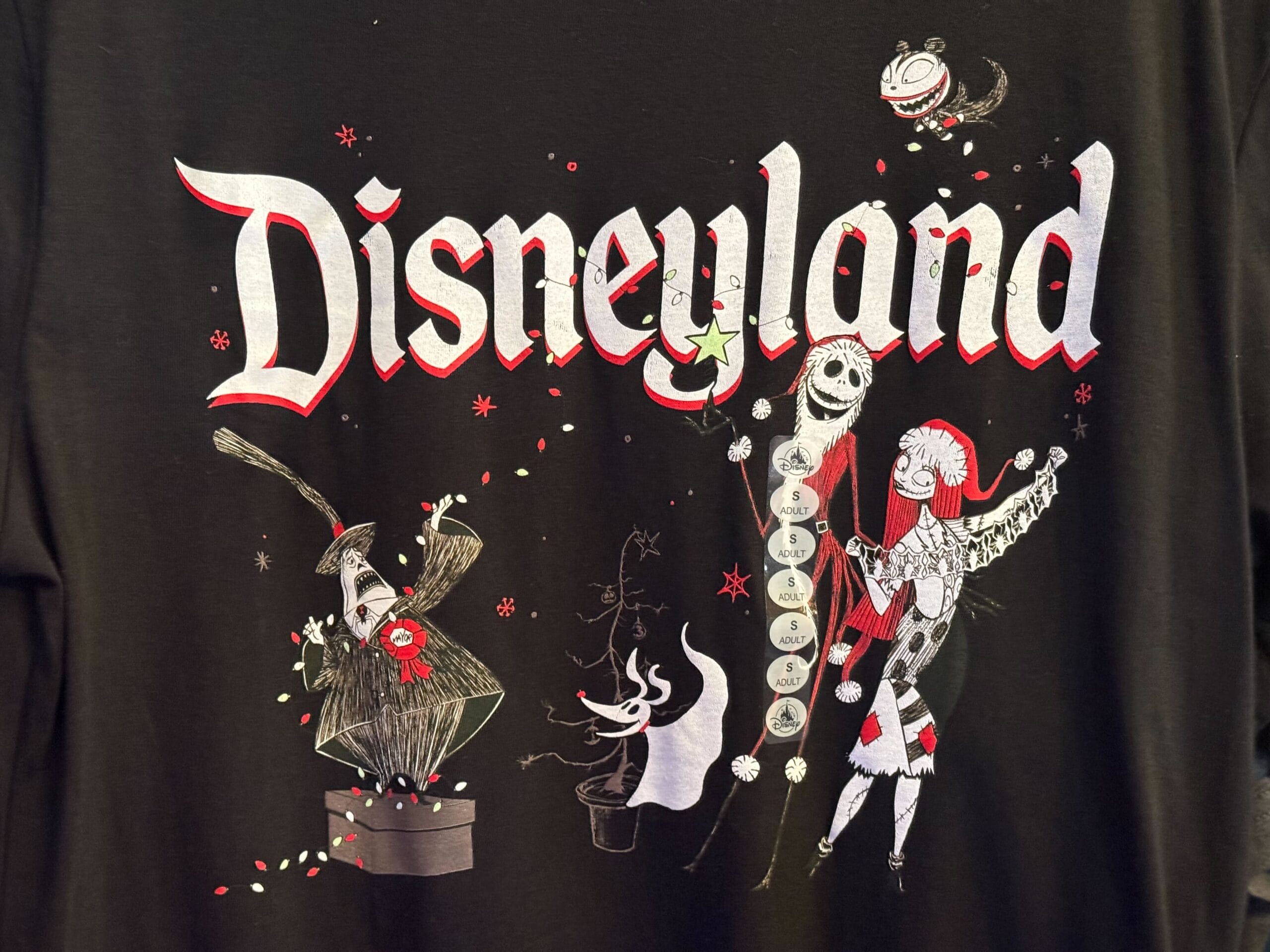 Black shirt with “Disneyland” text, plus Jack, Sally, and the Mayor in festive poses