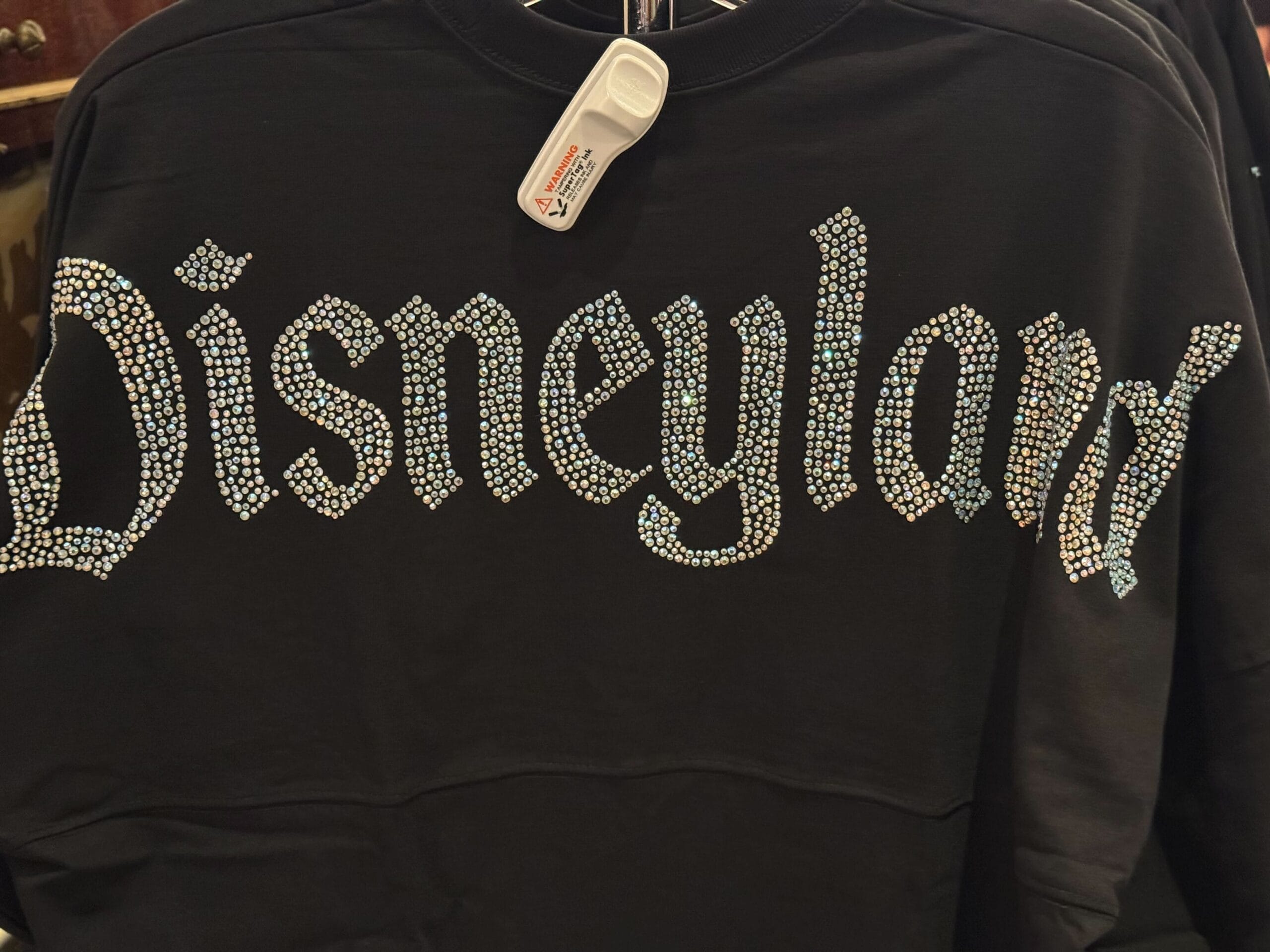 A black, rhinestone-studded Disneyland Spirit Jersey with sparkling lettering