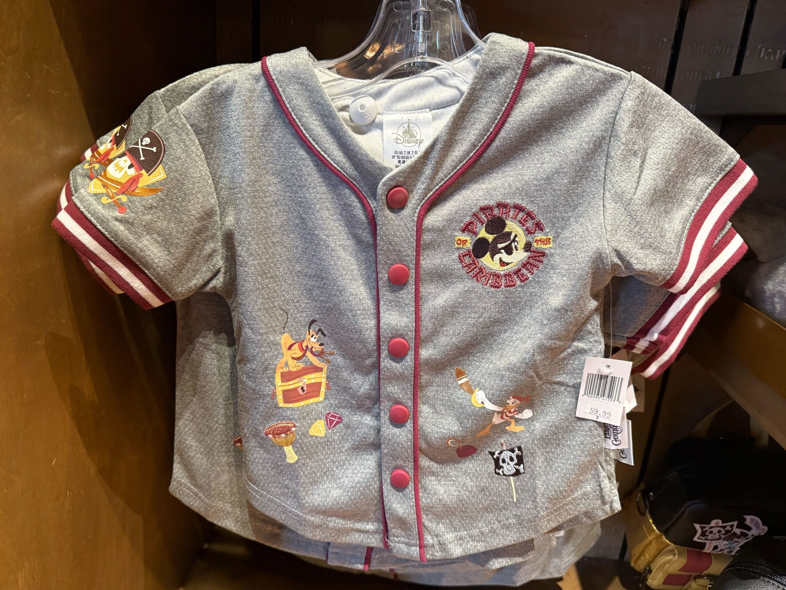 Gray baby jersey with red trim, Disney pirate graphics like Mickey Mouse with a treasure chest and pirate icons