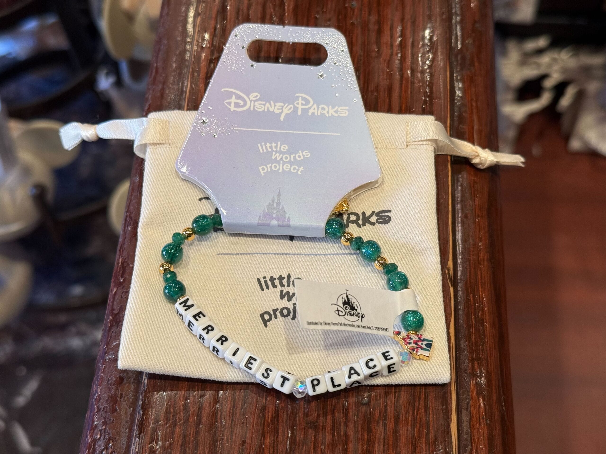 Disney Parks "MERRIEST PLACE" beaded bracelet with tag—festive 2025 holiday merch, reminiscent of Main Street castle decor.