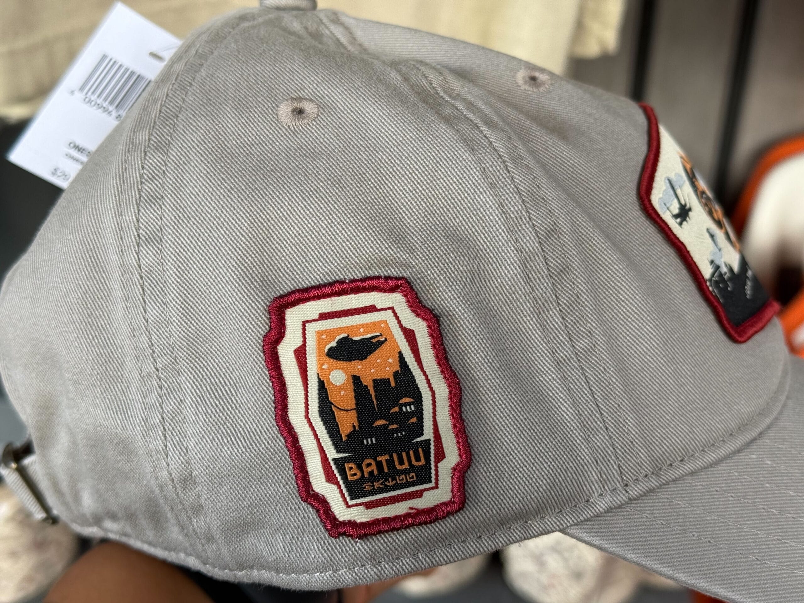 Gray baseball cap featuring a red-trimmed "Batuu" patch, echoing Star Wars Galaxy's Edge Resistance gear from Disney parks.