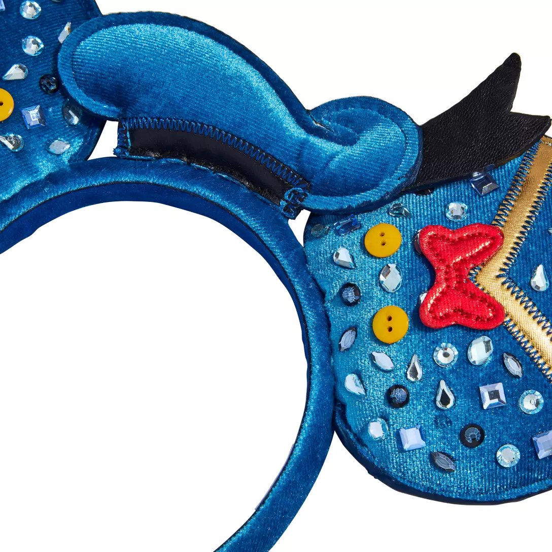 Blue sequined Disney mouse ears headband, adorned with buttons, gems, zippers, and a red bow reminiscent of Donald at Disney parks.