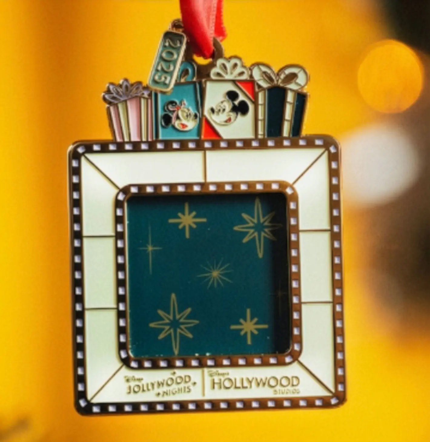 A Disney’s Hollywood Studios 2023 frame ornament with gifts, Mickey and Minnie on top—no castle like Magic Kingdom or Disneyland.