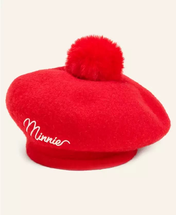 Bright red beret with a fluffy pom-pom from the Disney holiday collection, "Minnie" in white script, seen in Disney Parks.