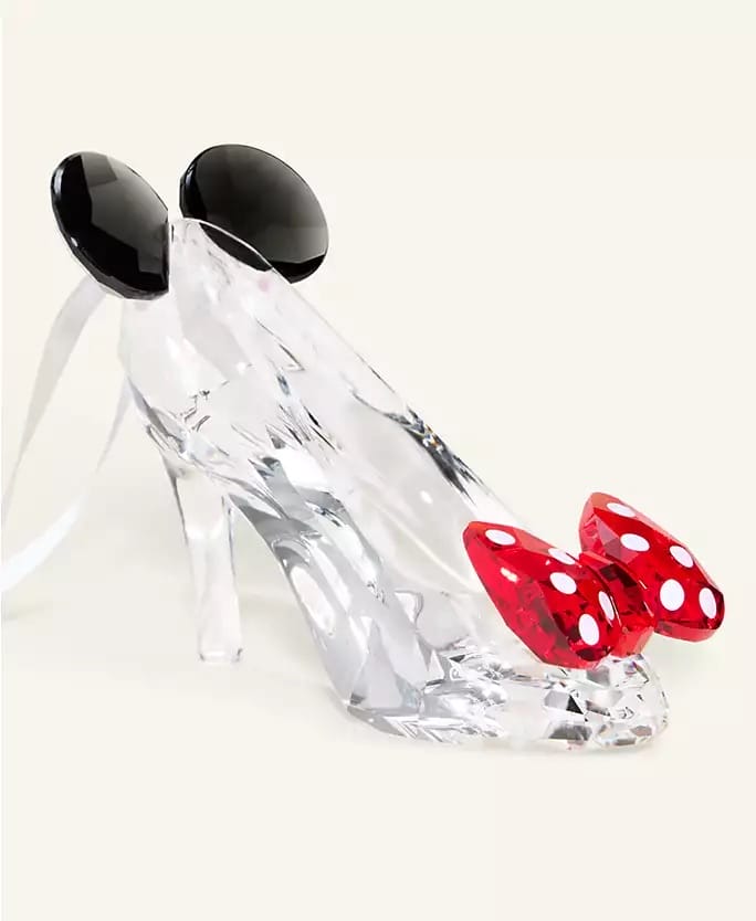 A glass high heel with mouse ears and a red bow, echoing Disney 2025 Holiday vibes, styled like park-exclusive merchandise.