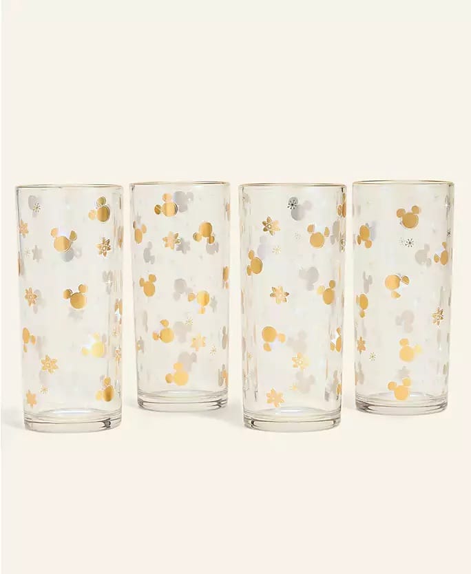 Four Disney Holiday Collection glasses, each with gold and silver Mickey heads and snowflakes—perfect for a festive park toast.
