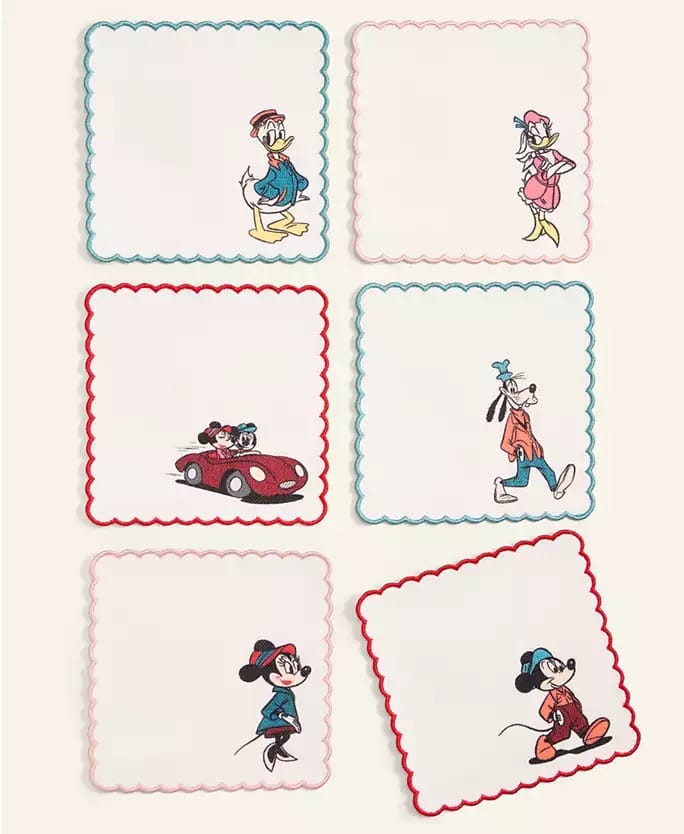 Six Disney Parks holiday napkins featuring embroidered characters; each evokes the festive spirit found in parks worldwide.