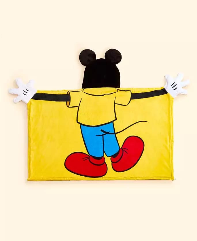 Yellow Mickey Mouse-inspired blanket, seen from behind, part of Macy's 2025 Disney holiday line; no castle featured here.