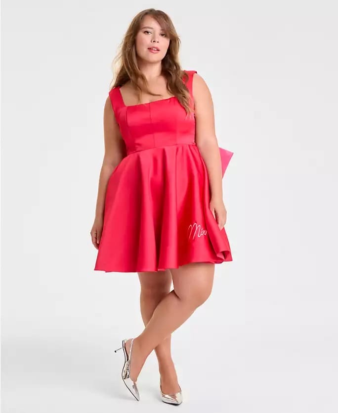 A woman in a pink sleeveless dress from Macy's Holiday Collection stands in silver heels, styled as if ready for a day at Disney parks.