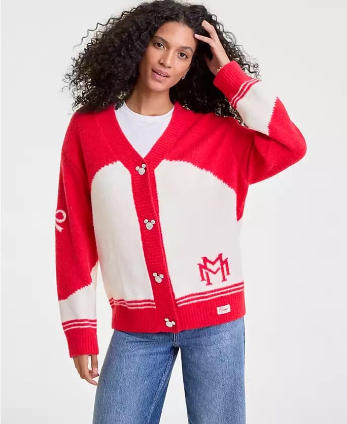 Woman in a red and white Disney cardigan with Mickey Mouse buttons and blue jeans, reminiscent of park attire at Disney Parks.