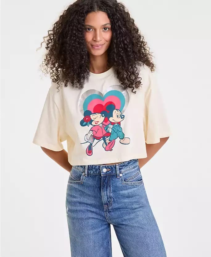 Woman with curly hair wearing a Disney Holiday Collection cropped tee and high-waisted jeans, similar to park styles, at Macy's.
