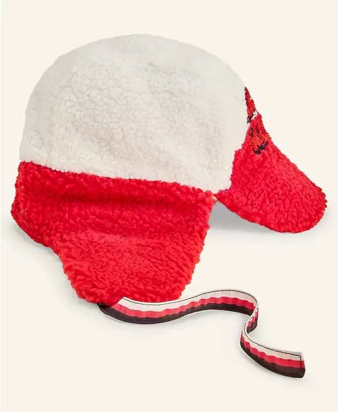 Red and white sherpa trapper hat with ear flaps from Macy's Holiday Collection, displayed like cozy winter wear in Disney shops.