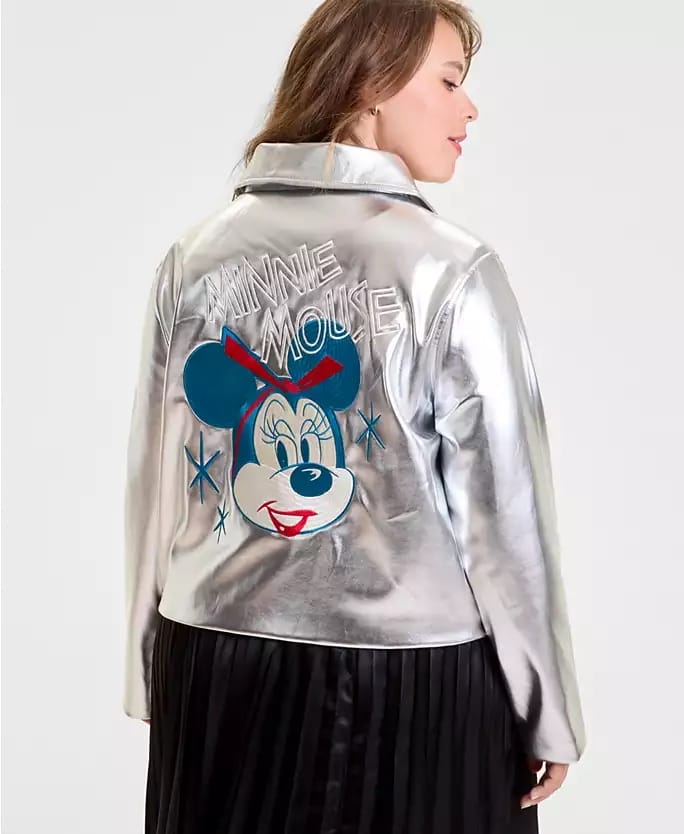 A woman wears a silver Disney 2025 Holiday Collection jacket with a large Minnie Mouse graphic, perfect for park visits.