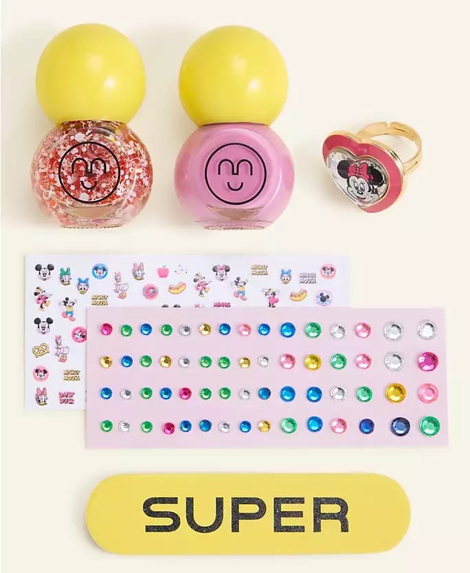 Disney's 2025 Holiday set: two nail polishes, Minnie Mouse ring, stickers, gems & nail file—no castle like at Disney Parks.