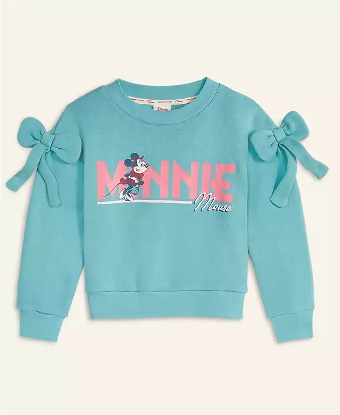 A blue Minnie Mouse sweatshirt from the Disney 2025 Holiday Collection, featuring large bows and pink-white lettering found at Disney parks.