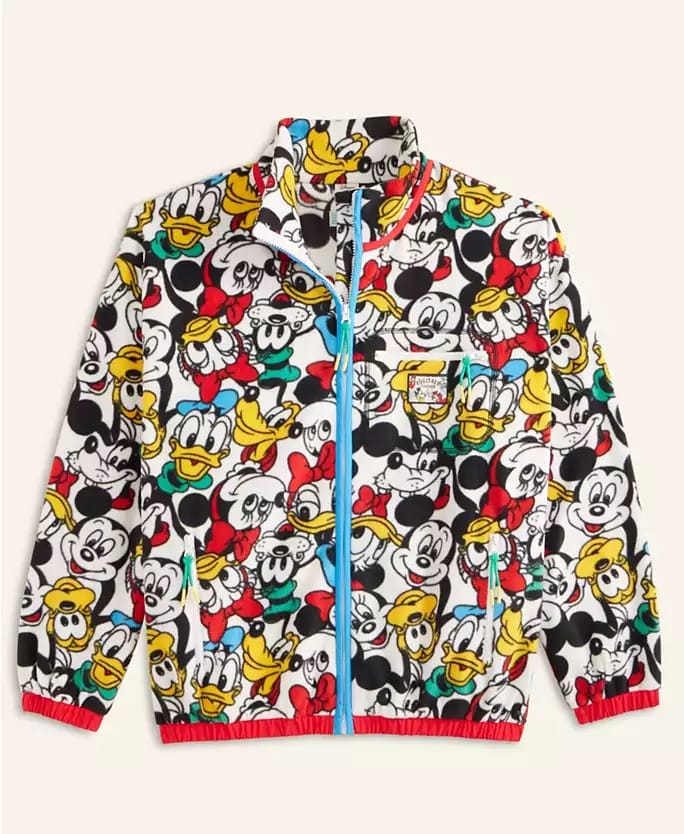 Vibrant Disney 2025 Holiday Collection jacket with Mickey, Donald, and Goofy in all-over park-inspired print, no castle visible.