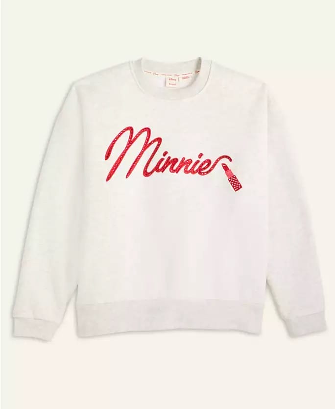 White sweatshirt from Macy's 2025 Holiday Collection with “Minnie” in red script, bow like Minnie at Disney parks.