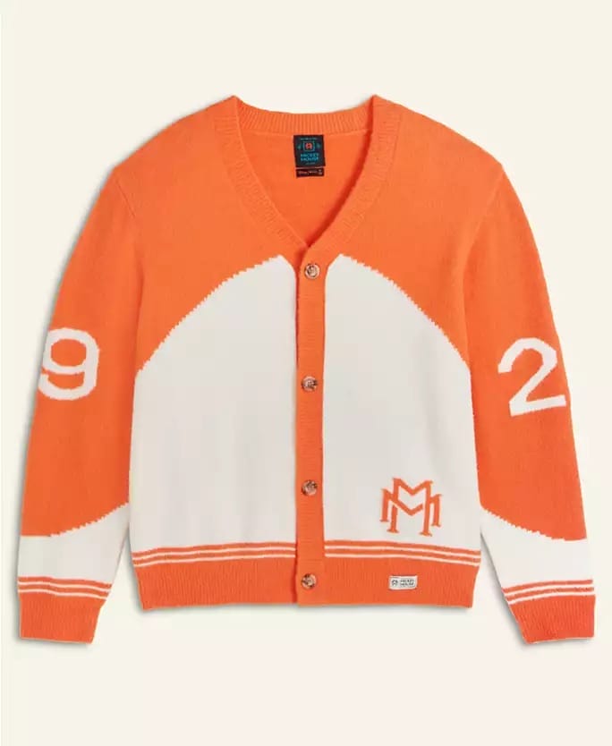 Orange and white Disney 2025 Holiday cardigan with buttons, sleeve numbers, and a front "M"—no castle like those in Disney parks shown.