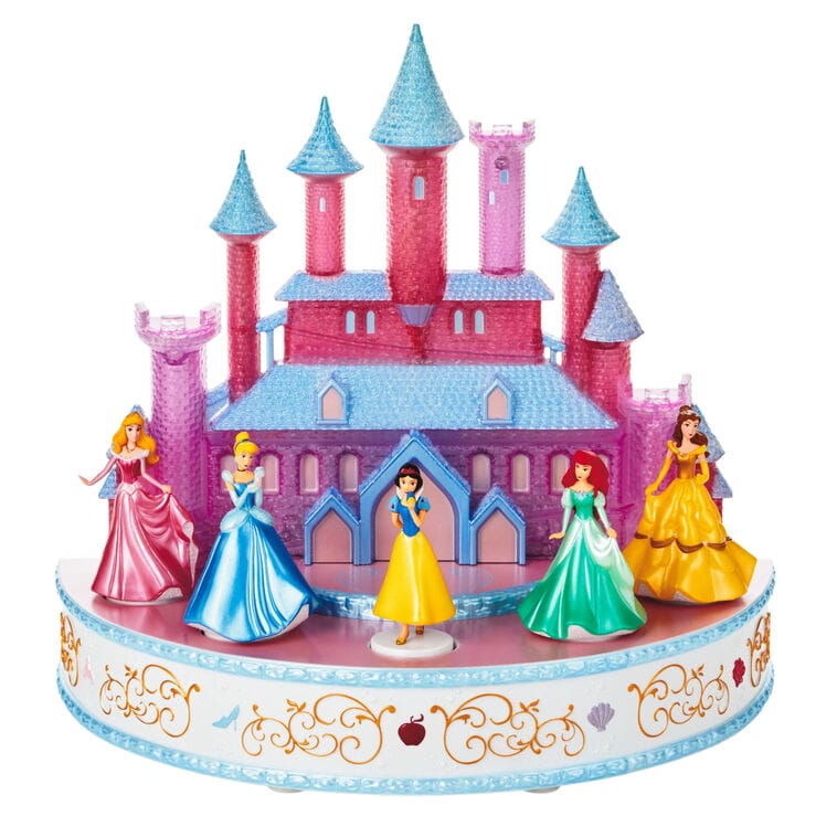 Vibrant toy castle resembling iconic Disney Parks castles, with five princess figurines, on an ornate base, Keepsake style.
