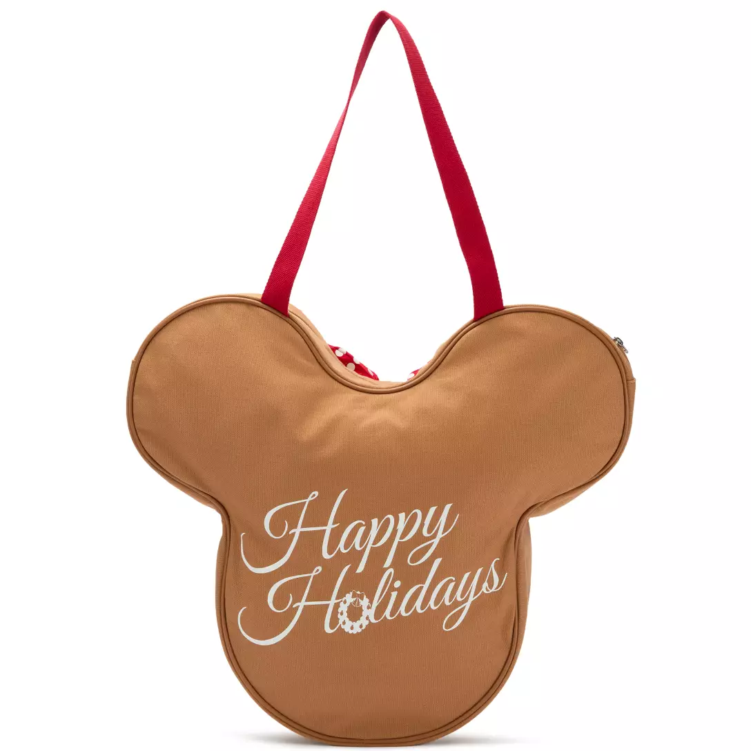 Tan Mickey Mouse-shaped tote with red handles, "Happy Holidays" in white script—perfect Disney Parks accessory for the holiday season.
