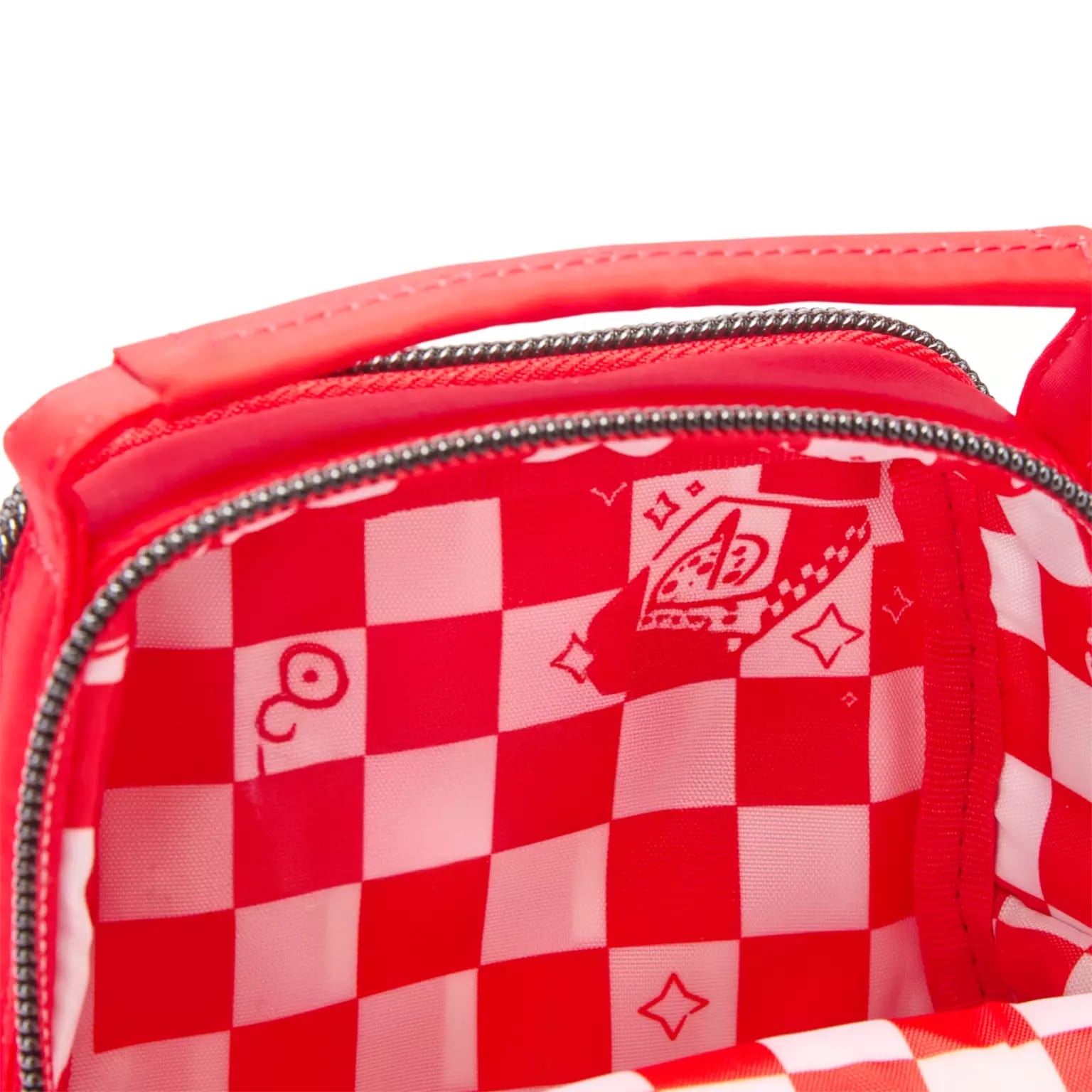 Open red crossbody bag with a whimsical checkered red and white lining, Disney-style cartoon touches, and card suits inside.