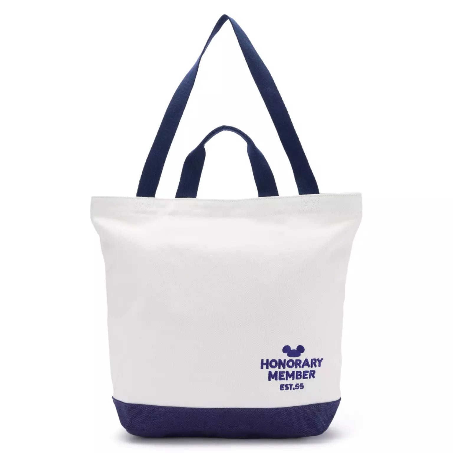White tote bag with dark blue handles, Disney Store-Exclusive Spirit Jersey, and "HONORARY MEMBER EST. 65" Mickey icon in blue.