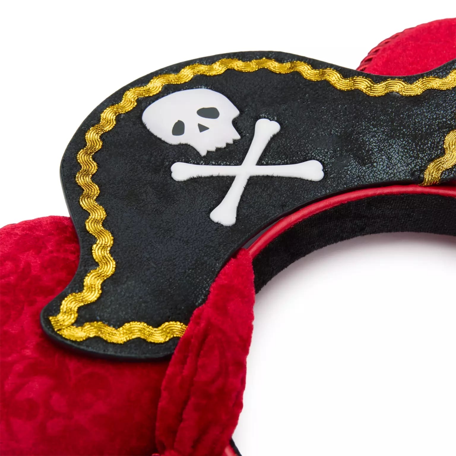 A Disney park pirate Mickey ear headband, featuring a black pirate hat, skull and crossbones, gold trim, and plush red ears.
