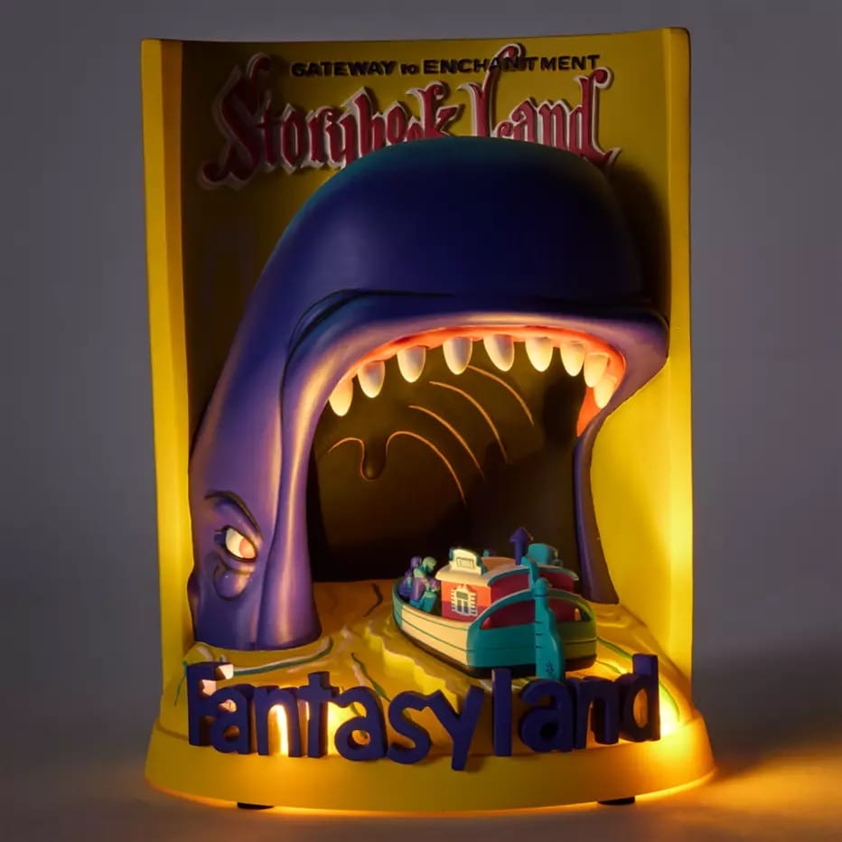A 3D Disney Attraction poster glows, featuring a boat entering a whale’s mouth below "Storybook Land," evoking park magic.