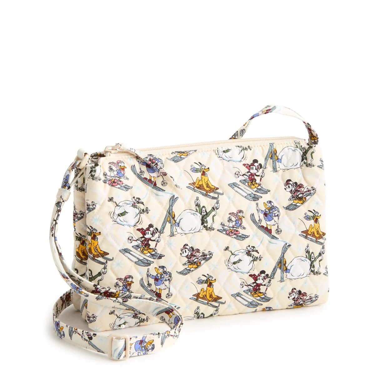 Cream Vera Bradley crossbody bag featuring Disney characters in Ski Weekend outfits amid snowmen and snowy scenes, reminiscent of winter festivities at Disney Parks worldwide. No castles are depicted to compare with iconic park castles.