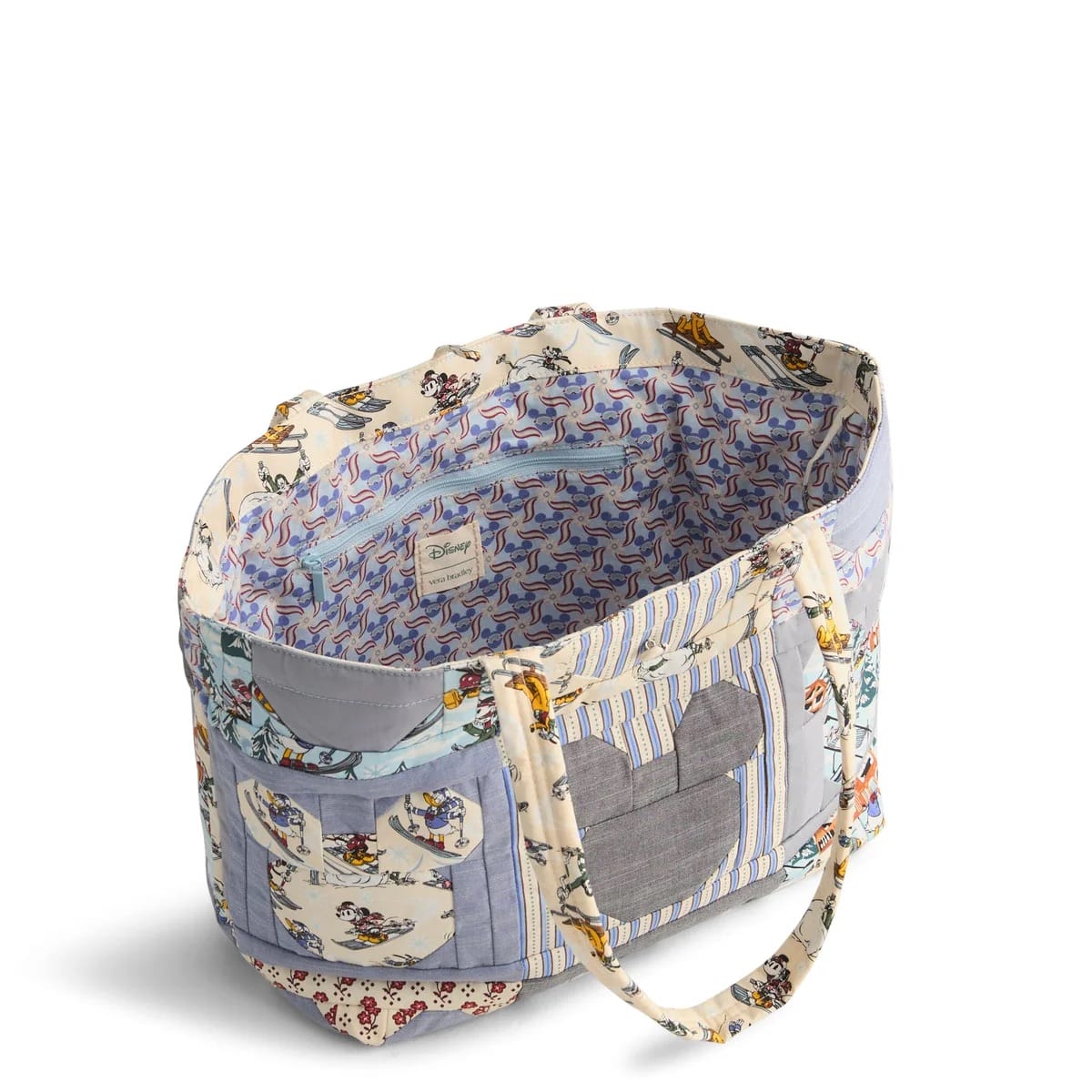 A fabric tote bag from the Vera Bradley Mickey & Friends Collection, with Disney park patchwork and a gray Mickey silhouette—no castle depicted.