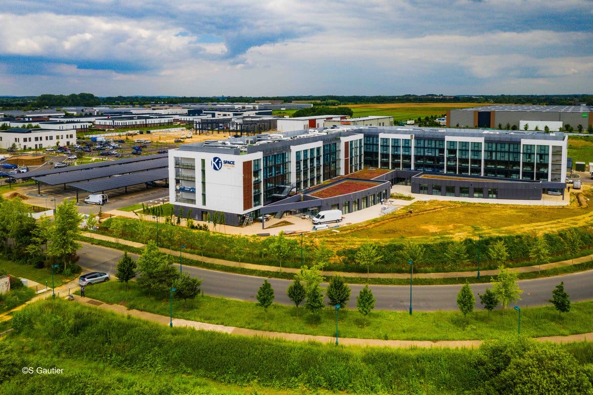 A sleek office with the Spac logo, surrounded by lush landscaping—unlike Disney park castles, no whimsical turrets stand here.