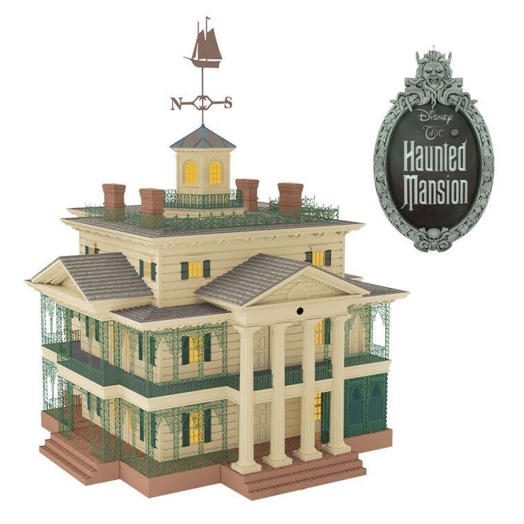 Detailed model of Disney's Haunted Mansion with glowing windows and green trim, a Hallmark Keepsake Ornament release; not a castle.