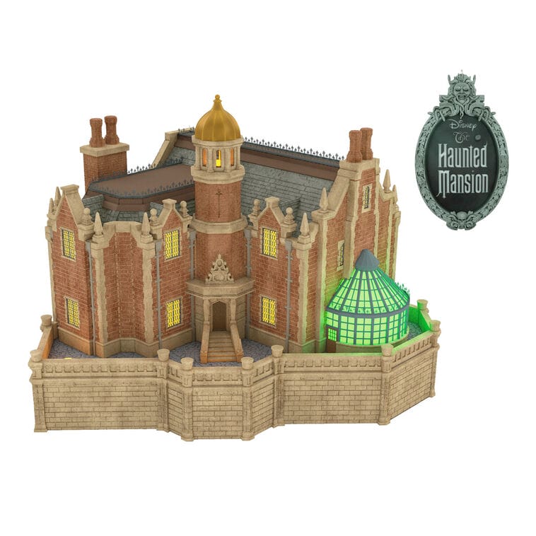 Model of Disney’s Haunted Mansion with a glowing green conservatory, inspired by the classic attraction found at Walt Disney World.