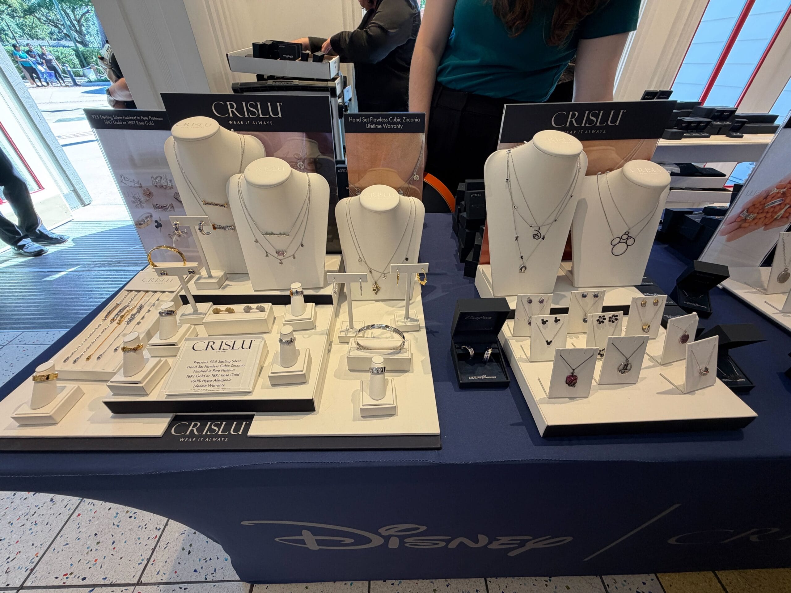 Table display of CRISLU Disney-themed jewelry at a retail Halloween Trunk Show, with necklaces, earrings & bracelets inspired by motifs seen in Disney Parks around the world.