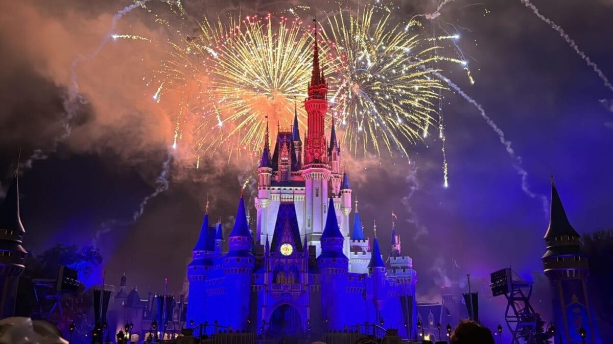A luminous castle reminiscent of Disney’s Cinderella Castle dazzles under vibrant fireworks—a magical sendoff from Terminals MCO.
