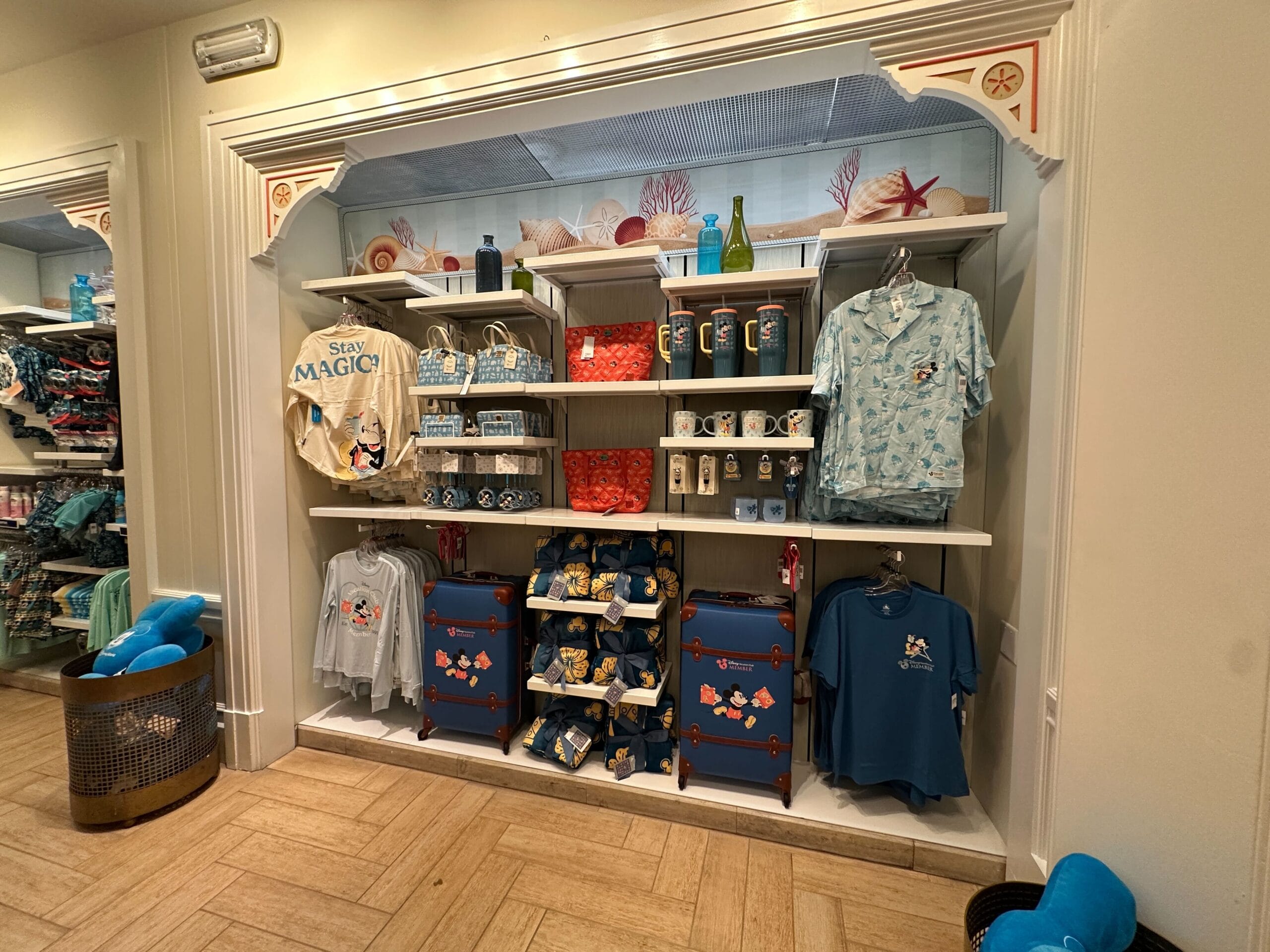 Disney-themed merchandise display with shirts, mugs, and snacks—perfect for a Jane Goodall daily recap souvenir.