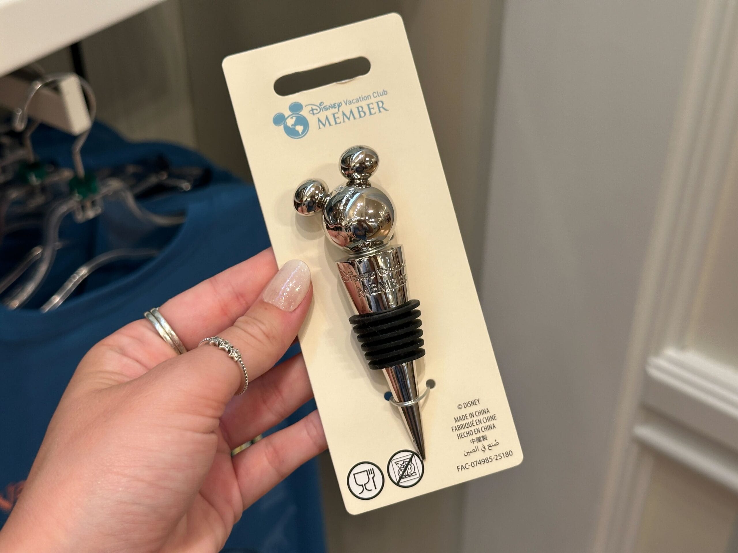 Hand holding a DVC Member Merch bottle stopper shaped like Mickey Mouse’s head from the New Collection at Grand Floridian.