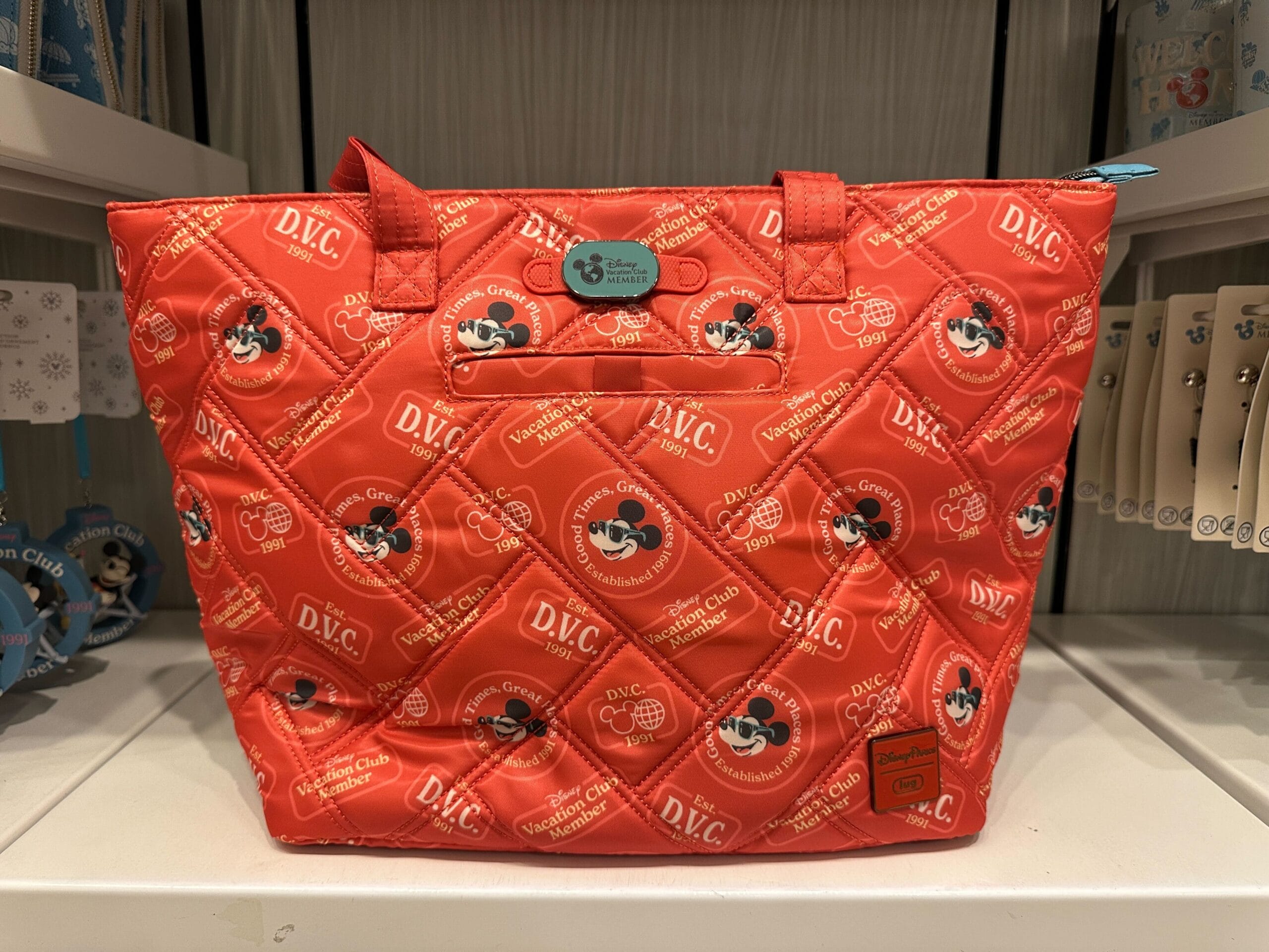 Red quilted Disney bag from the New Collection featuring Mickey Mouse and DVC Member Merch at Grand Floridian.