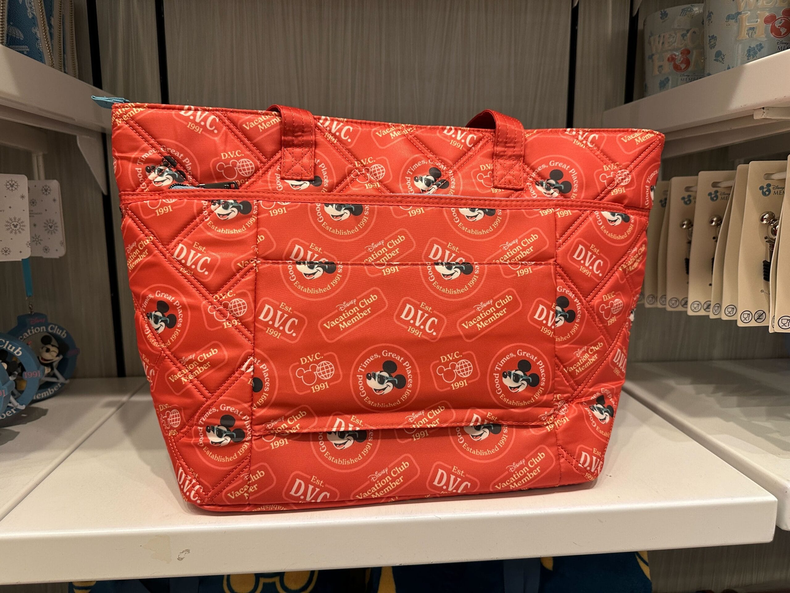 Red quilted tote bag with Mickey Mouse and Disney Vacation Club logos—part of the new DVC Member Merch collection.