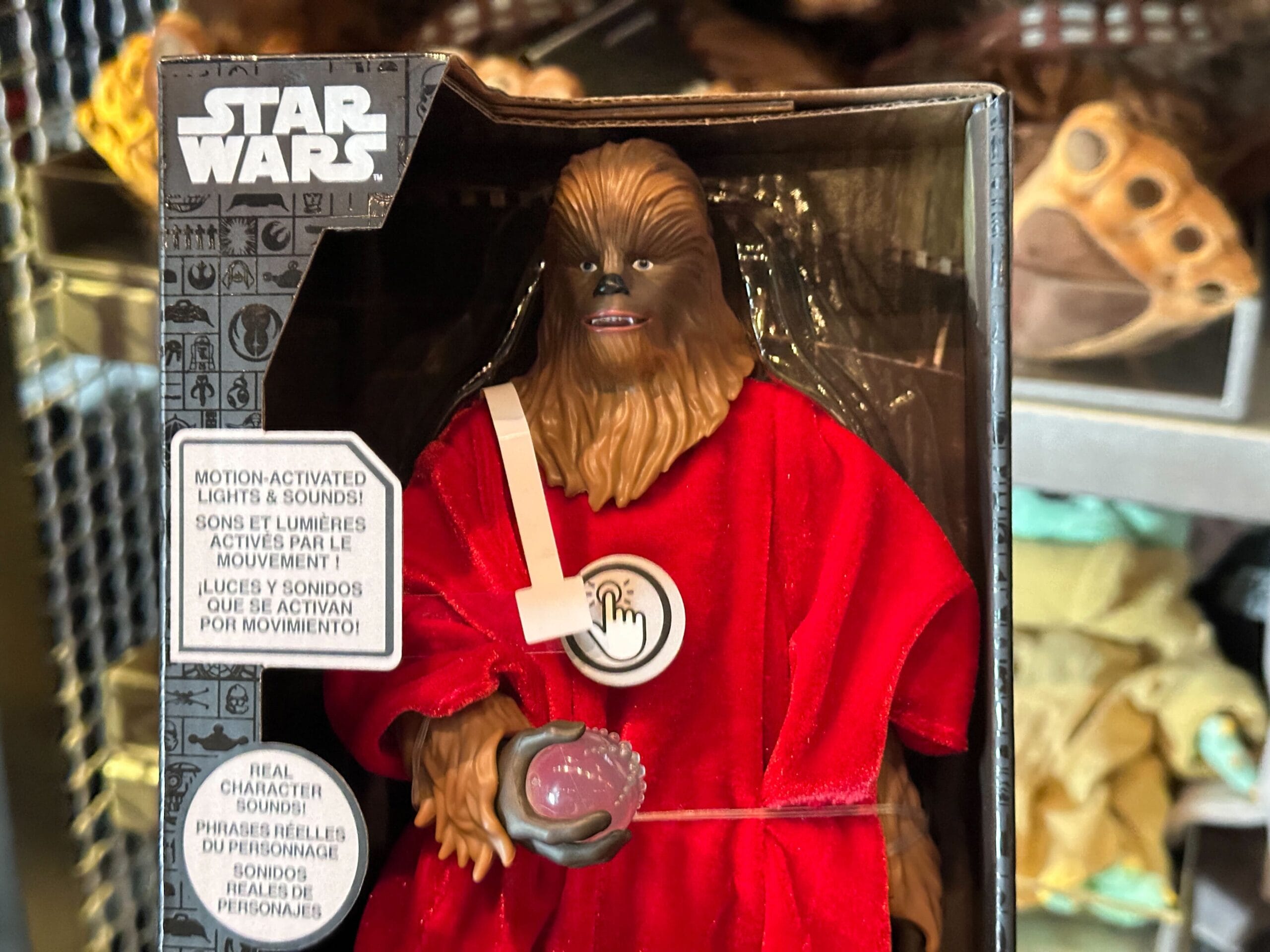 Close up of Life Day Chewbacca action figure in a red robe and holding an orb.