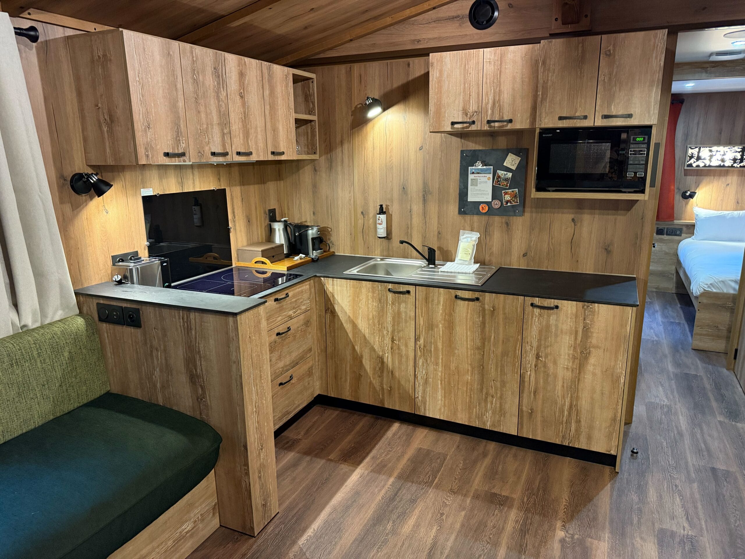 Cozy wooden kitchenette with black counters in a cabin at Davy Crockett Ranch at Disneyland Paris.