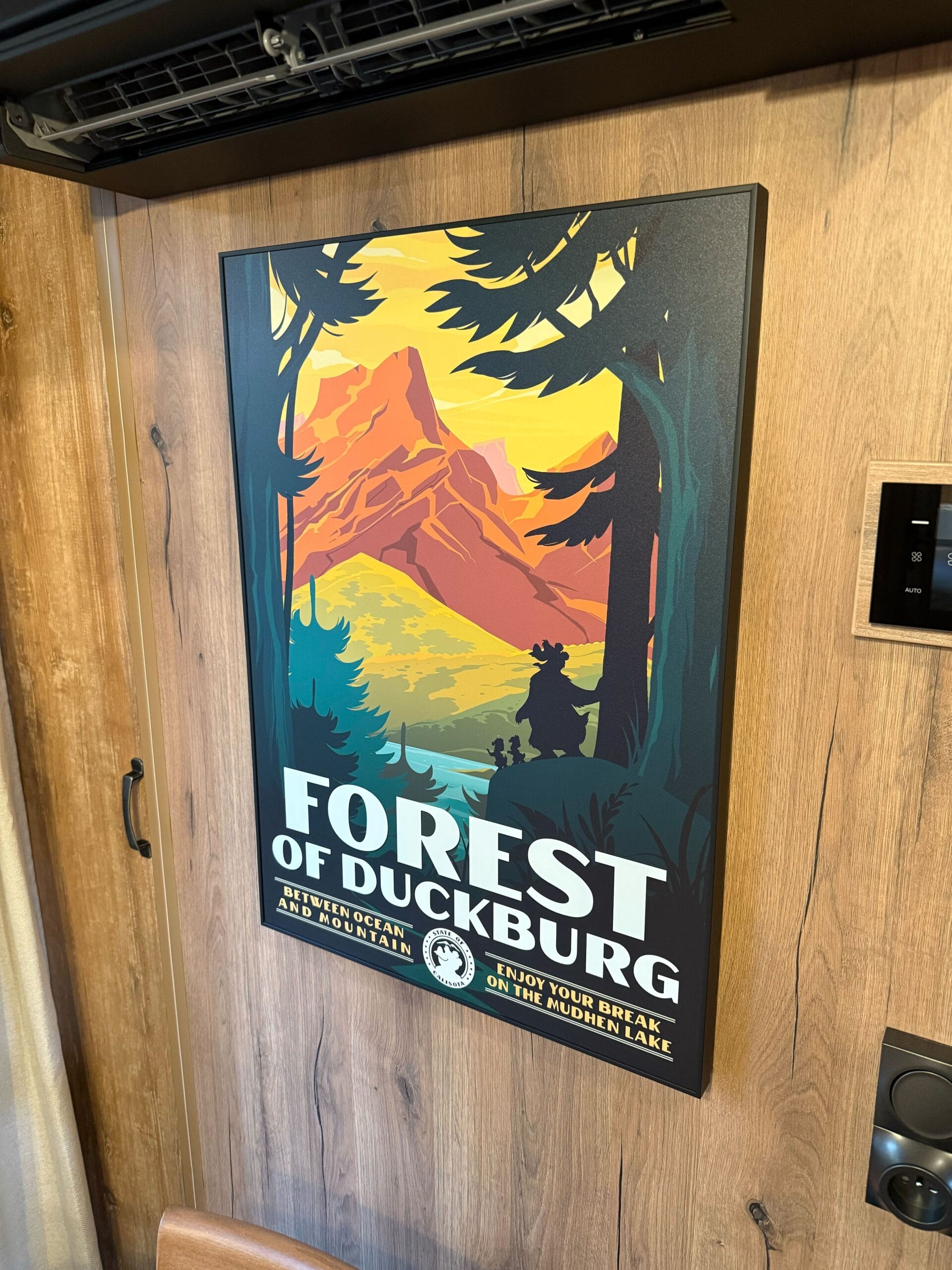 A vibrant poster reads "Forest of Duckburg" with a mountain scene in a cabin at Davy Crockett Ranch at Disneyland Paris.