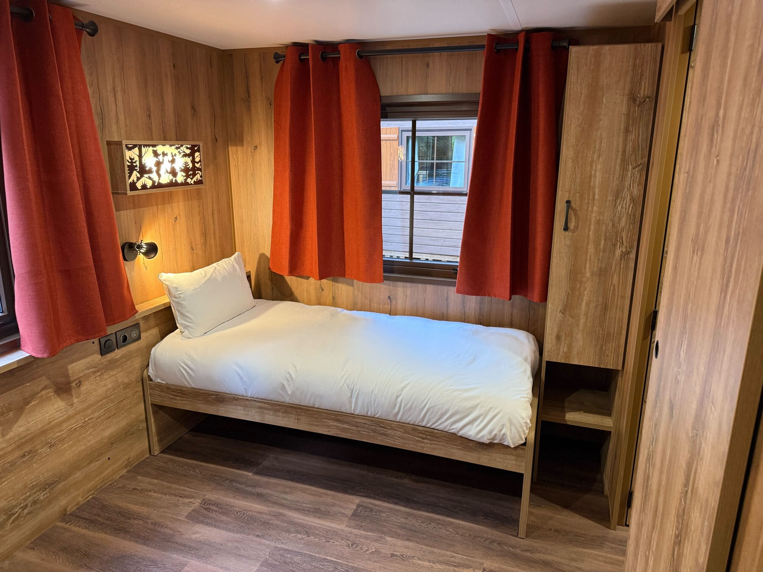 A single bed in a refurbished cabin at Disney Davy Crockett Ranch at Disneyland Paris.