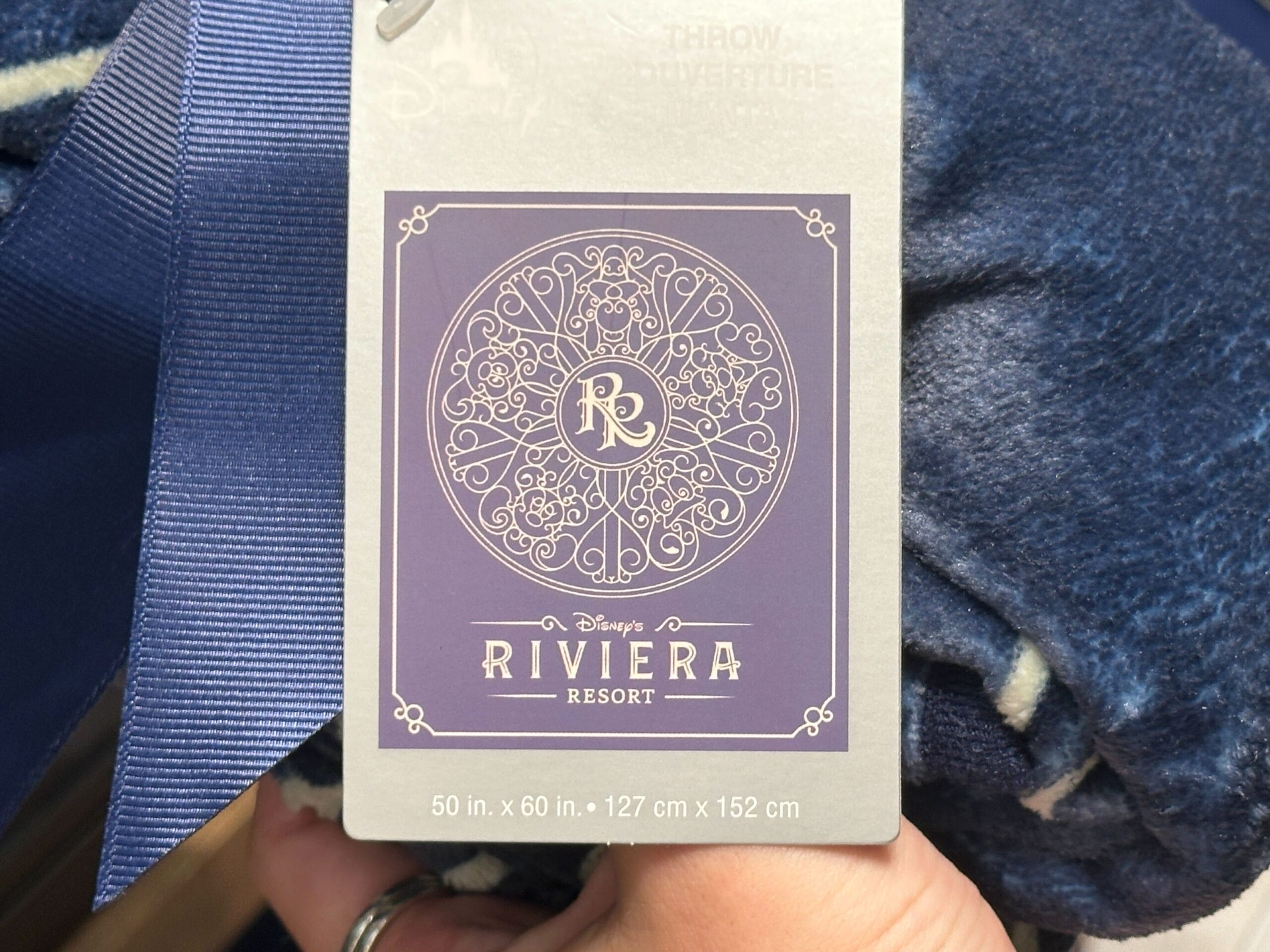 Disney's Riviera Resort throw blanket tag, new arrival, 50x60 in. (127x152 cm), featuring resort logo—no castle depicted.