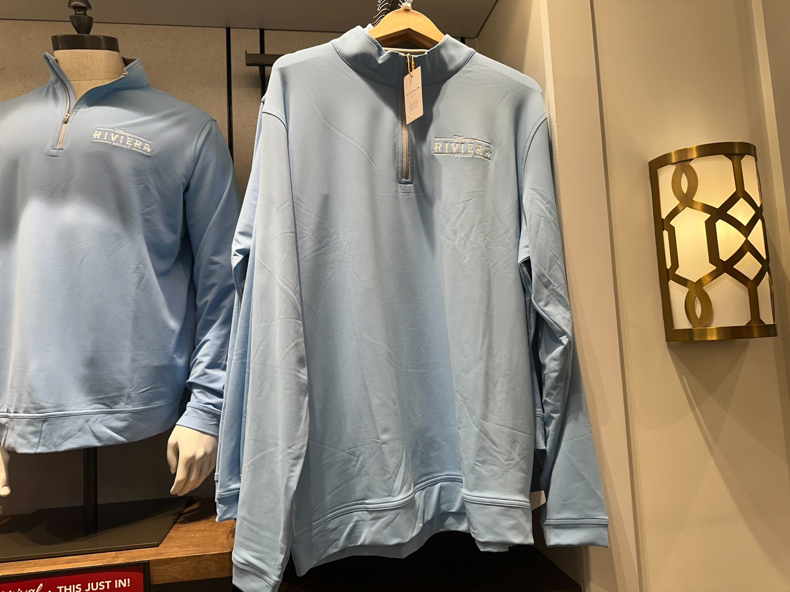 Light blue Riviera Resort pullover, Disney Parks exclusive, displayed by new arrivals—no castle in view to compare park locations.