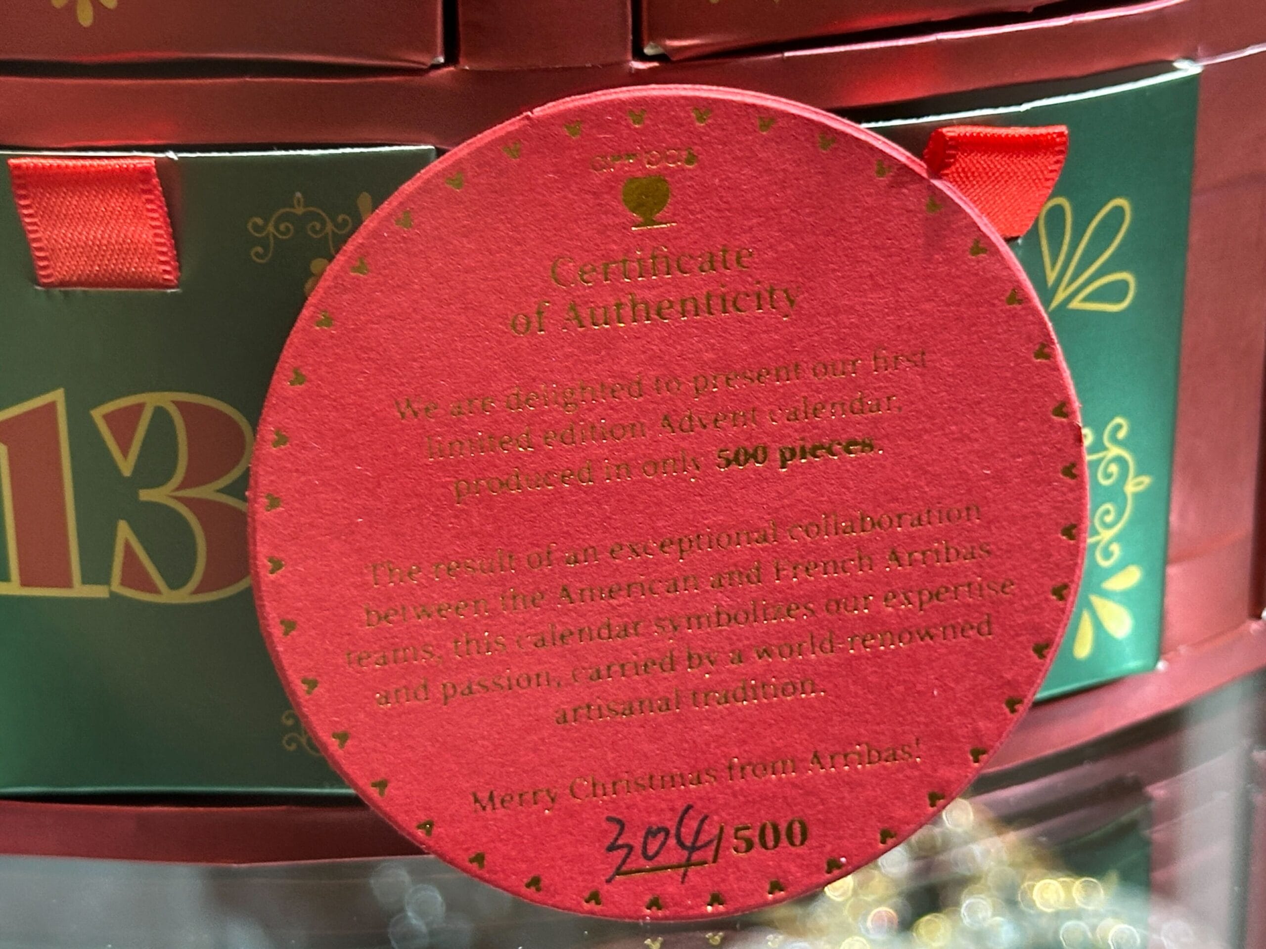 Round red Certificate of Authenticity for the Arribas Brothers advent calendar.