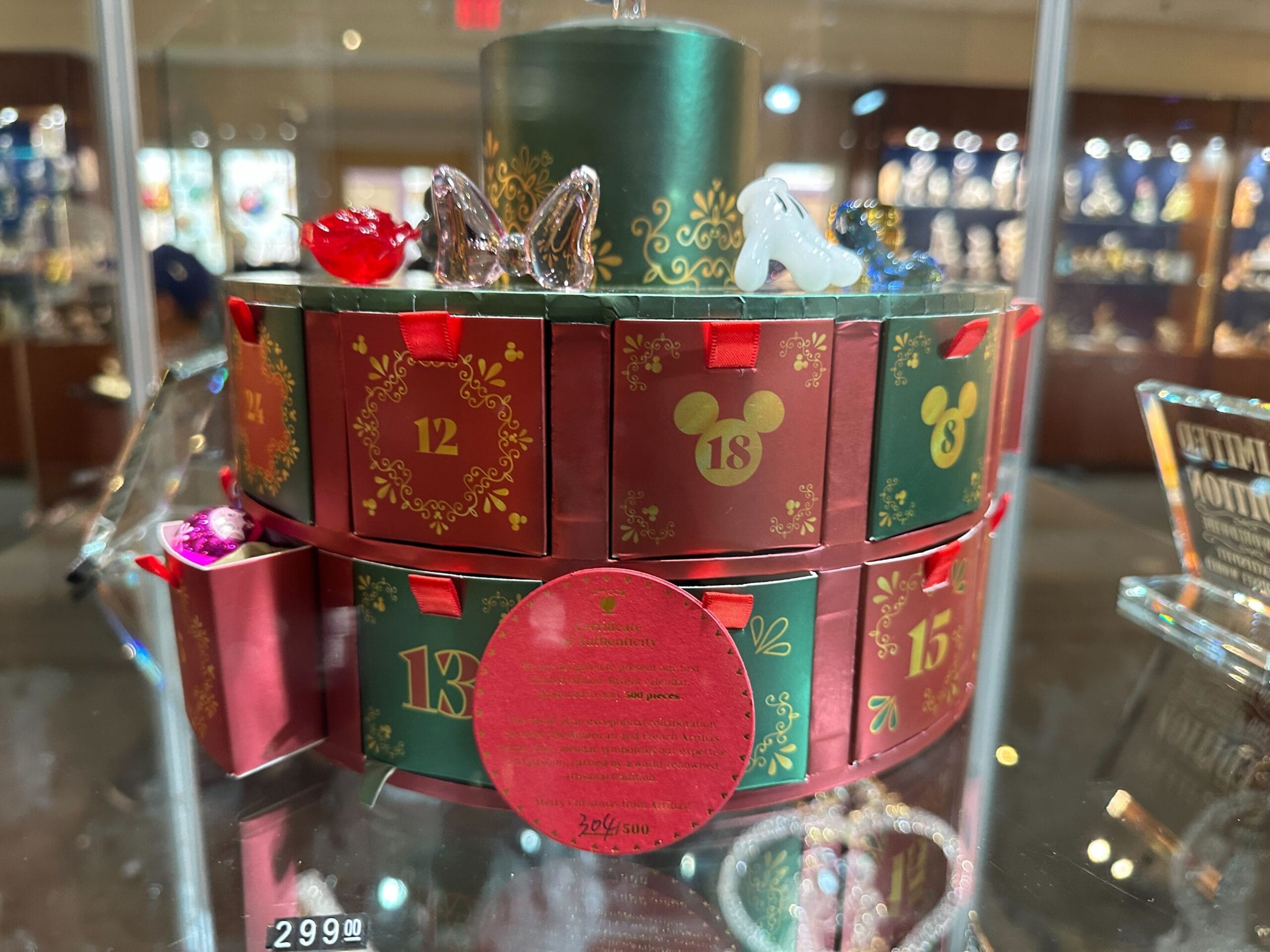 An Arribas Brothers advent calendar featuring glass figurines and ornaments with numbered drawers in a store case at Crystal Arts at Walt Disney World.